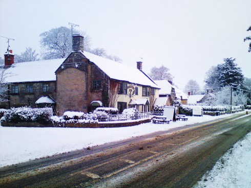 A typically devastating scene showing what can happen when snow falls on an English pub.